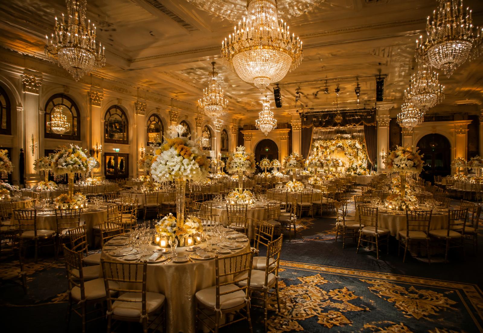 Grand wedding banquet hall lit by chandeliers